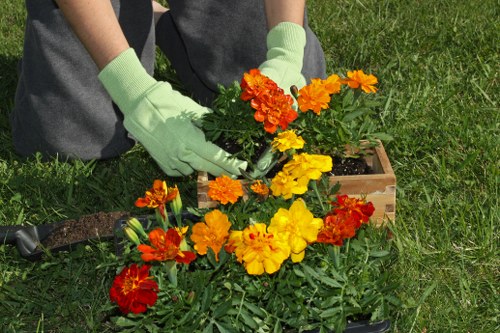Landscapers safely loading garden rubbish and checking site hazards